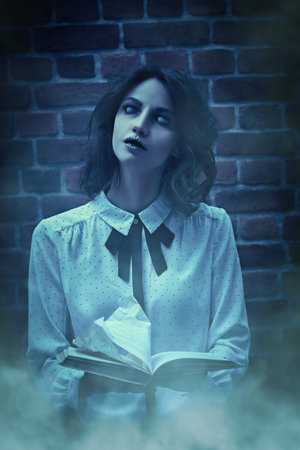 Horror scene. A ghost girl with faded eyes stands in a gloomy room against a brick wall, surrounded...