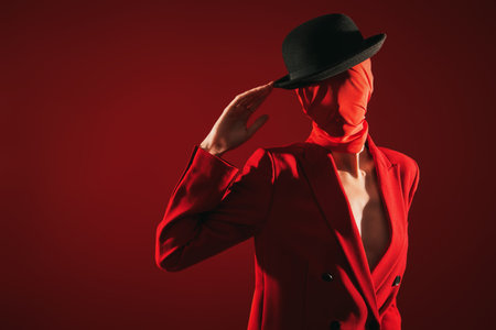 Fashion and red color. Portrait of a high fashion female model posing in red suit, red chiffon...