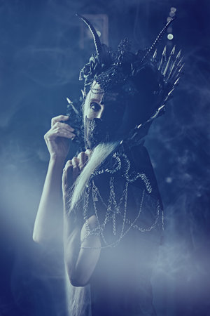 Fairy tale evil Queen, Witch. Portrait of a stately and beautiful old woman with long gray hair, in...