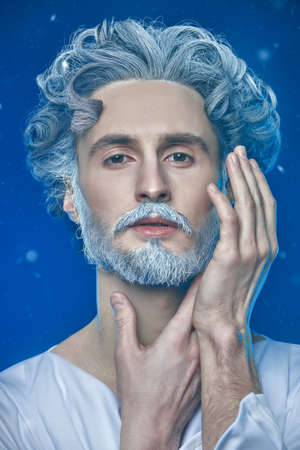 Art image of God. Close up shot of a divine man with a beard and curly hair on a blue background. Roman and Greek mythology, Christianity and religion.の写真素材