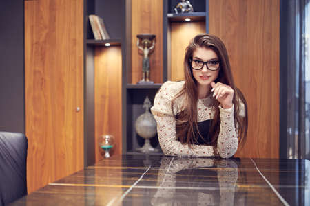 Business concept. Modern businesswoman sitting at the table in her office.の写真素材