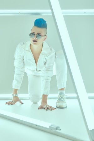 A beautiful girl punk rock musician with a cool mohawk and stylish sunlasses in a futuristic cyber...