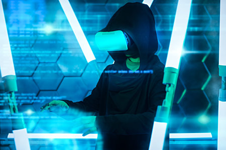 Virtual technologies of the future. A modern teen boy in a hoodie uses virtual reality glasses for...