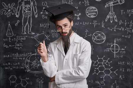 Science and education. A smart enthusiastic professor stands at the blackboard with scientific...