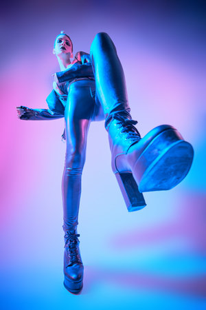 Portrait of a slim fashion model posing expressively in stylish black leather clothes and...