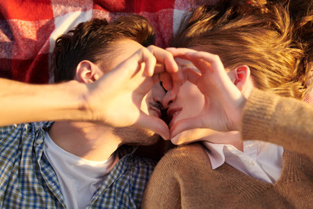 Sweet and tender love. Close up portrait of a beautiful young couple lying on the blanket...