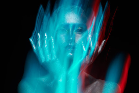 Art, beauty and fashion. Studio portrait of a girl with painted sparkling silvery skin in aquamarine...