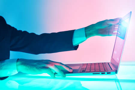 The hands of a male business analyst work on a laptop managing business processes. Modern business technologies. Business concept.の写真素材