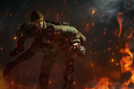 A courageous soldier carries his wounded comrade on his shoulders from the battlefield engulfed in...
