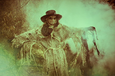Halloween. A scene of horror, when an evil terrible Scarecrow with a bag on his head, in a sackcloth...