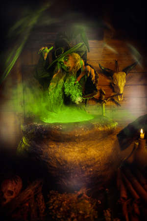 Scary Halloween tales. Portrait of a dangerous and frightening witch brewing a potion in her cauldron in a dark lair.の写真素材