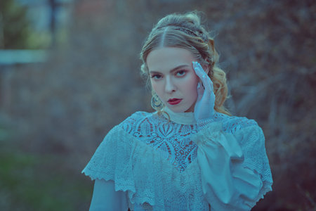 Historical reconstruction of the Victorian era. Portrait of a beautiful noble lady in a white dress...