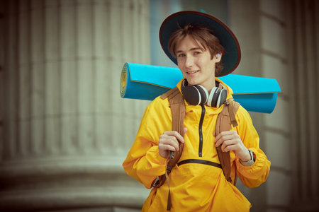 Children's and teenage tourism, holidays. Portrait of a modern teenage boy who travels on vacation...