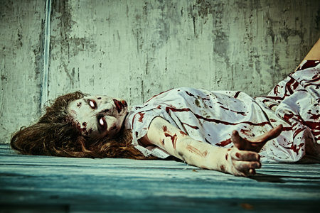 A terrible disfigured woman, possessed by the devil lies in a dark room covered in blood after the...