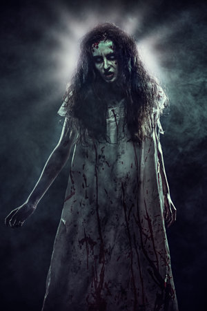 Creepy obsessed woman covered with blood standing in a dark room, surrounded by night fog. Heavenly...