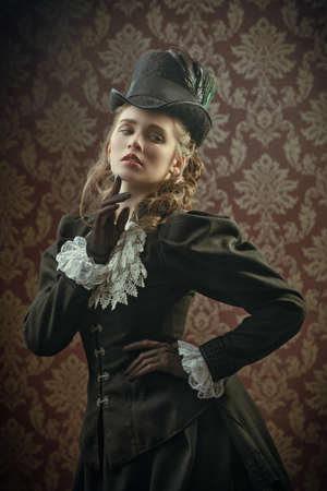 Vintage portrait of a beautiful elegant victorian lady in a 19th century dress. 19th century fashion and beauty. Steampunk lady.の写真素材