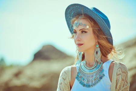 Summer bohemian and modern hippie style. Beautiful fashion model girl in boho jewelry and clothes...