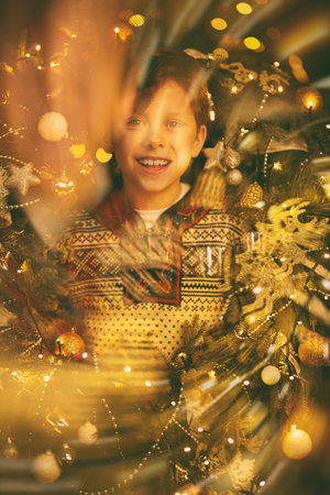 Portrait of a happy boy standing with a big decorated wreath around his neck and joyfully smiling....