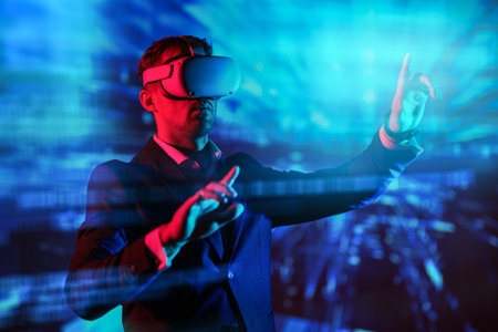 A businessman in Virtual Reality glasses manages a 3D-hologram of his business. Business strategies and tactics. Information technologies of the future.の写真素材