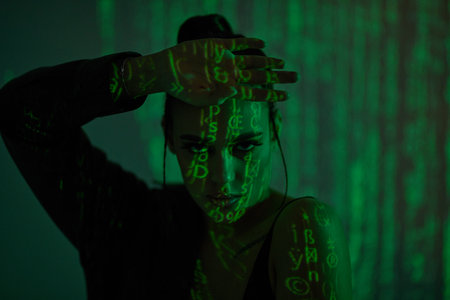 Cyber girl of the future. Portrait  of an attractive confident girl among light and shadows of the matrix. The matrix style.の写真素材