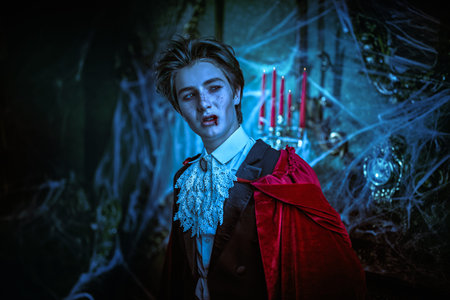 Vampires. A teenage vampire aristocrat stands in an abandoned medieval castle and grins evilly. A...