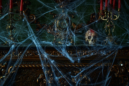 Halloween scary stories.Dark scary room in the old vintage castle with Halloween decorations, pumpkins and cobweb around.の写真素材