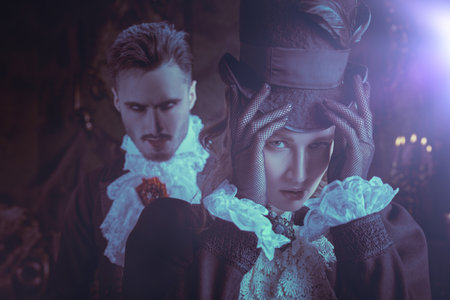 Vampires of the 19th century. Portrait of a pretty innocent young lady in the lair of an attractive and frightening vampire. Halloween.の写真素材