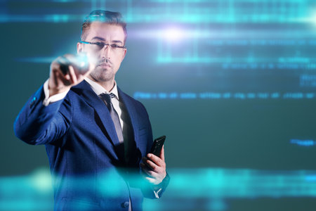 Modern business and information technologies. Portrait of a successful businessman with a phone in his hand working with digital holograms. Business concept. Copy space.の写真素材