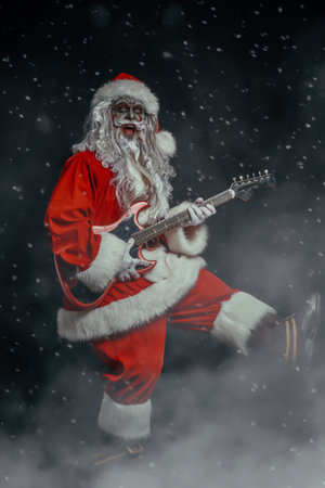 Zombie night party on Christmas and Halloween. Scary and cool rock musician zombie Santa Claus sings and plays electric guitar. Black background with a smoke.の写真素材