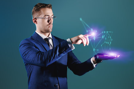 Portrait of a serious male businessman or politician managing a digital hologram. Green background.の写真素材