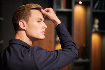 A profile portrait of a well-groomed serious businessman standing in his respectable office. Business concept.の写真素材