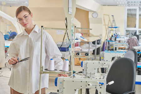 An occupation of a beautiful young woman seamstress working in a sewing shop. Fashion industry....