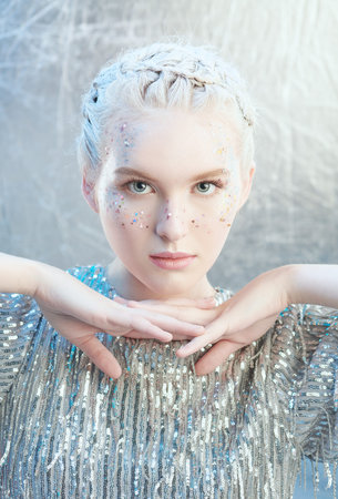 Christmas and New Year party look. A beautiful tender girl with light shining make-up with sparkles...