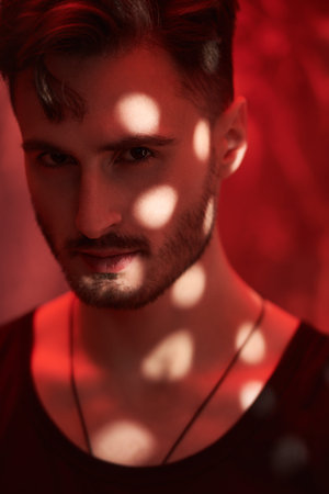 Men's emotions and beauty. Art portrait of a masculine handsome brunette man, who is looking ahead...