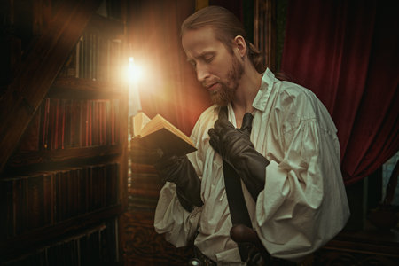A handsome nobleman musketeer in a white shirt with wide sleeves stands in the library in the family...