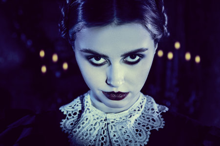 Close-up portrait of a gloomy serious girl with black hair, black eyes and black lips, who stands in...