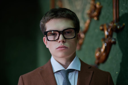 Men's fashion and beauty. A portrait of a handsome young man in a formal suit and stylish spectacles...