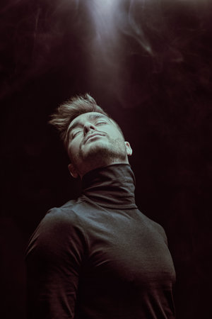 A shot of a calm and pensive man on a black background with closed eyes. Business concept. Psychology.の写真素材