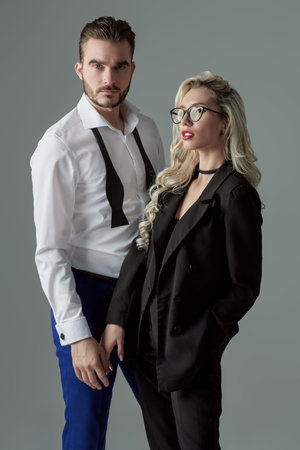 Portrait of a beautiful glamorous couple in elegant classic dresses. Evening Fashion. Studio...