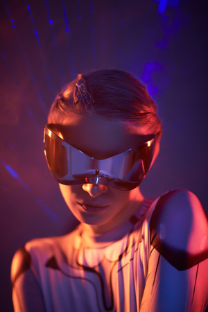 Portrait of a beautiful cyber girl in futuristic glasses standing against the background of reflections of fire, fiery rays. Ð¡osmic style. Cyberspace, virtual reality games.の写真素材