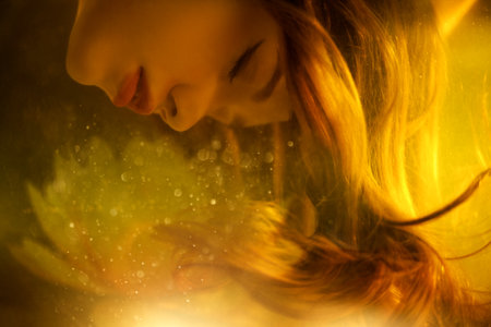 A beautiful fairy-tale girl with long hair descends underwater with her eyes closed. Water art fantasy. Mermaid, water nymph.の写真素材