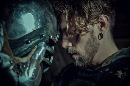 Tales of knights. A portrait of a handsome noble medieval knight in armor standing in a castle. Historical reconstruction. Fantasy.の写真素材