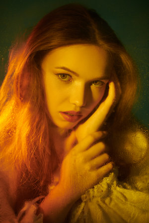 Fantasy. Art portrait of a beautiful tender girl in a vintage white dress, who is looking at the camera.の写真素材