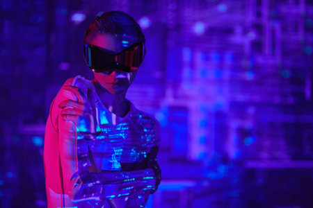 Perfect cyber girl in futuristic glasses and overalls stands among digital hologram in neon blue and crimson light. Digital technologies of the future. VR games. Cyberspace.の写真素材