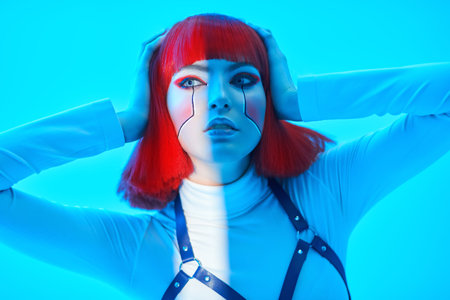 Concept of cyberpunk. Portrait of a beautiful cyberpunk girl with bright red makeup and red hair...