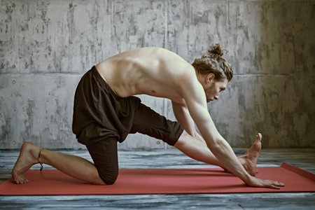 Sport and healthcare. Portrait of a handsome middle aged man doing yoga on a gray studio background. People and health. Lifestyle.の写真素材