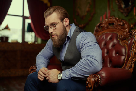Handsome well-groomed male gentleman in a classic respectable suit with a vest and shirt in a...