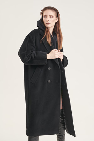 Fashion for women. Portrait of a stylish confident woman in a black felt coat. White studio background.の写真素材