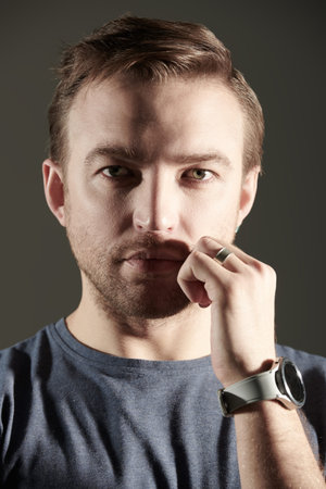 Shot of a confident middle aged man in blue t-shirt. Men's health and beauty. Studio portrait on a...