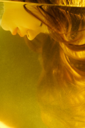 Water art fantasy. A beautiful fairy-tale girl with long hair descends underwater with her eyes closed. Mermaid, water nymph.の写真素材